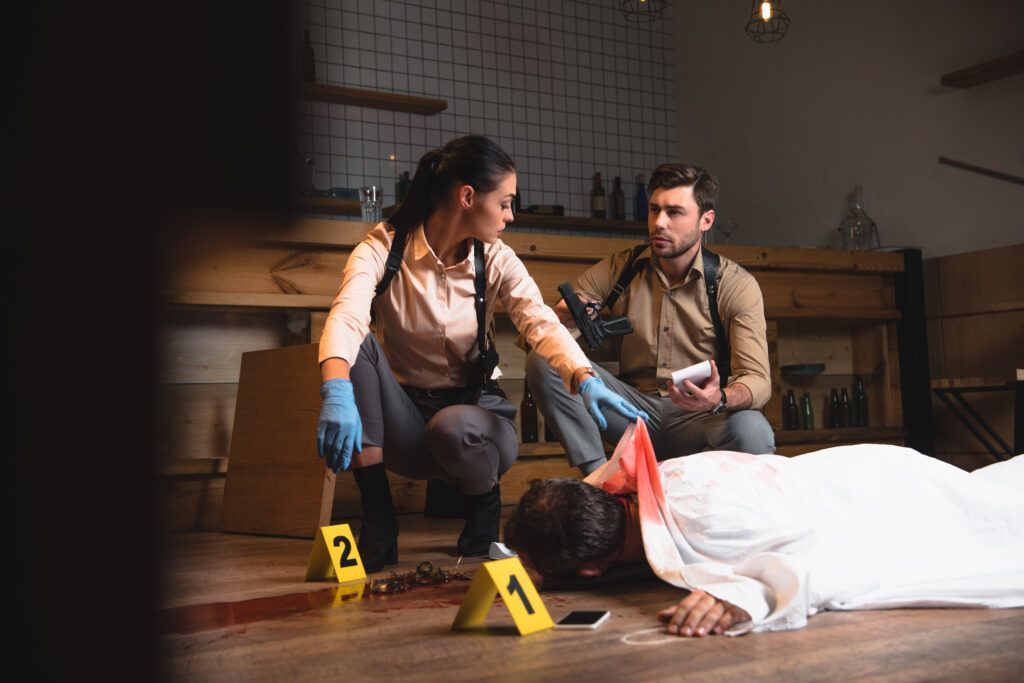 Police investigators examining a homicide scene during a criminal investigation related to murder and manslaughter charges in Canada.