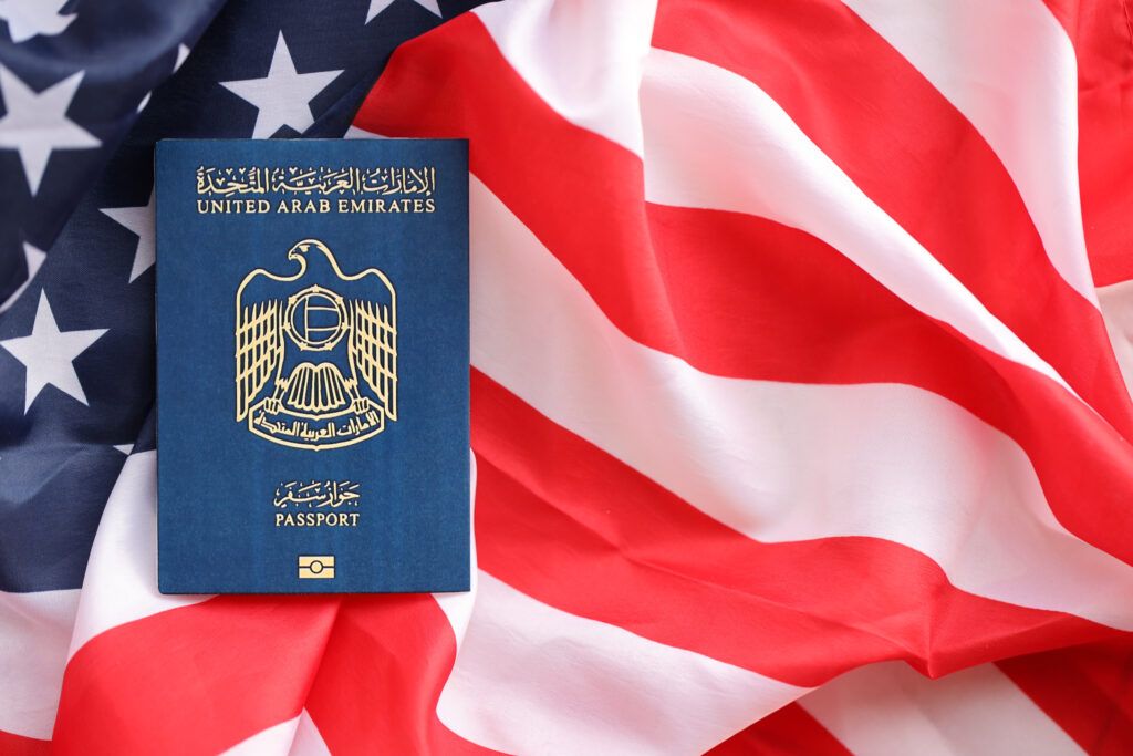 United Arab Emirates passport placed on an American flag, symbolizing US immigration consequences and travel restrictions after a criminal conviction.