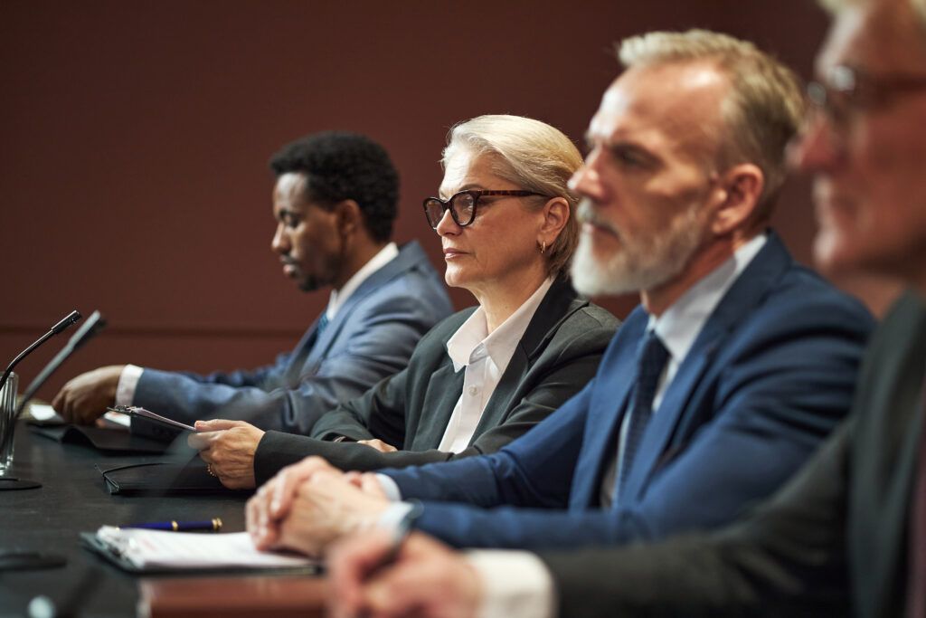 Individuals seated in a courtroom setting during a bail hearing where a surety may be assessed by the court.