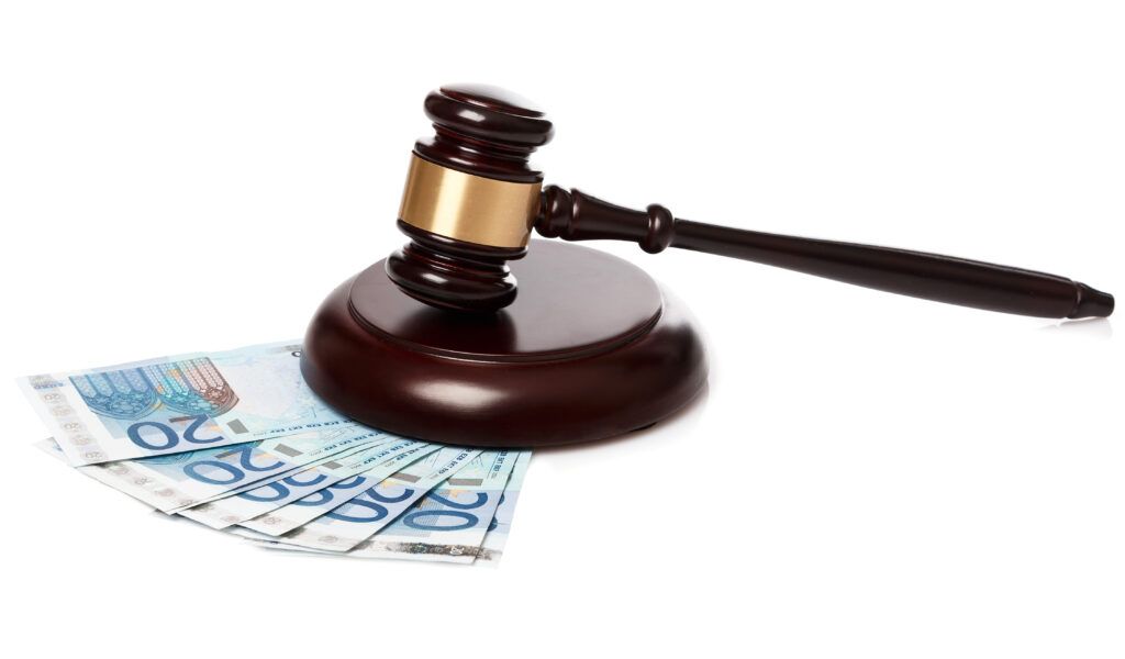 Judge’s gavel beside Canadian currency, representing the Victim Fine Surcharge under s. 737 of the Criminal Code.