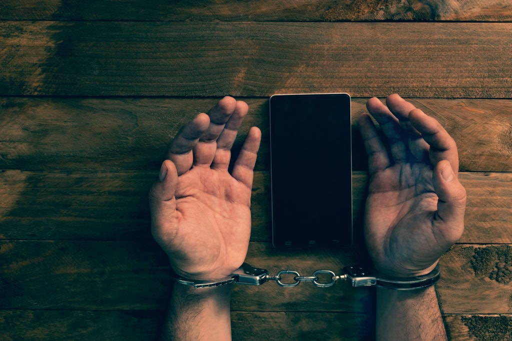 Crime concept in the network using a smartphone.