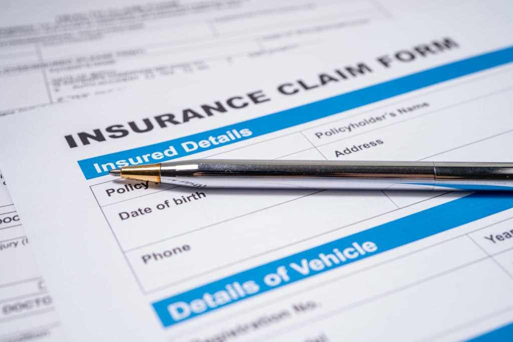 Pen on Insurance claim accident car form, Car loan, insurance an