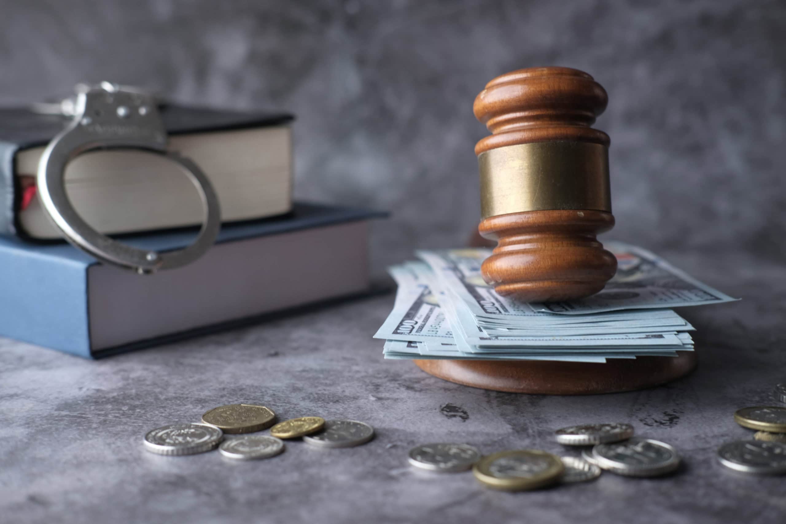 An exploration of the Legal Justice Concept featuring Handcuffs, a Gavel, and Cash money