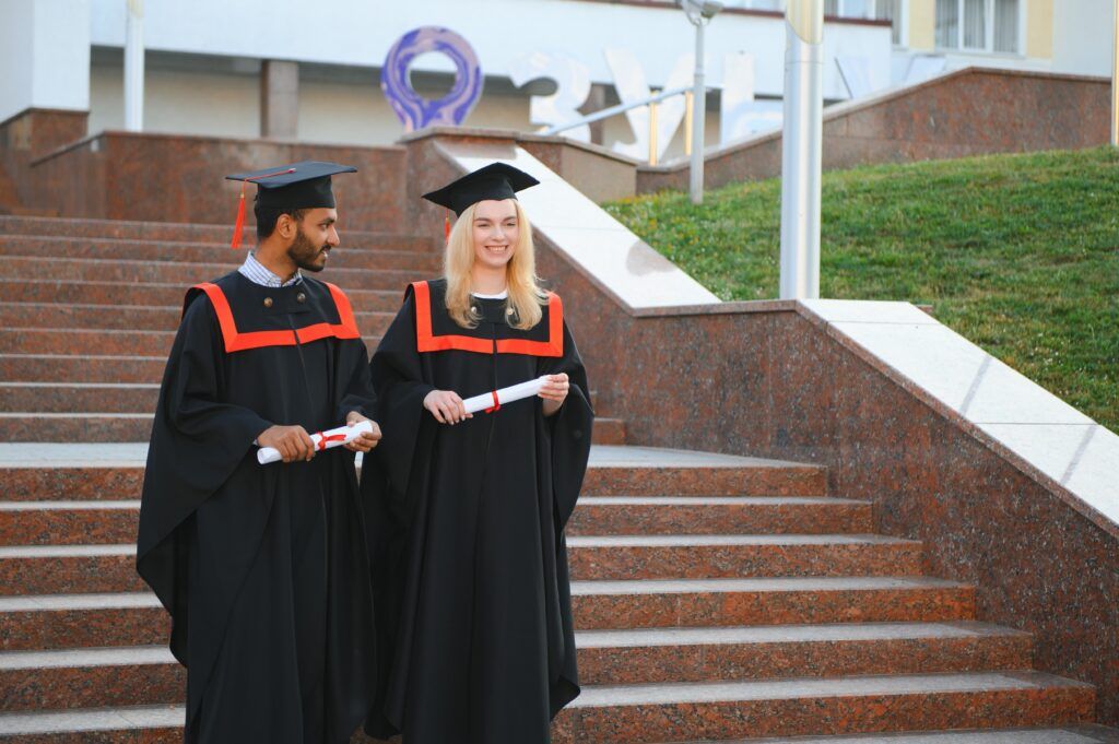 Graduates holding diplomas during a formal ceremony, symbolizing formal admissions and statements with legal significance.
