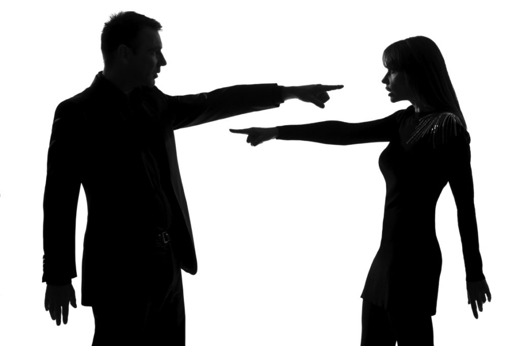 man and woman pointing and arguing