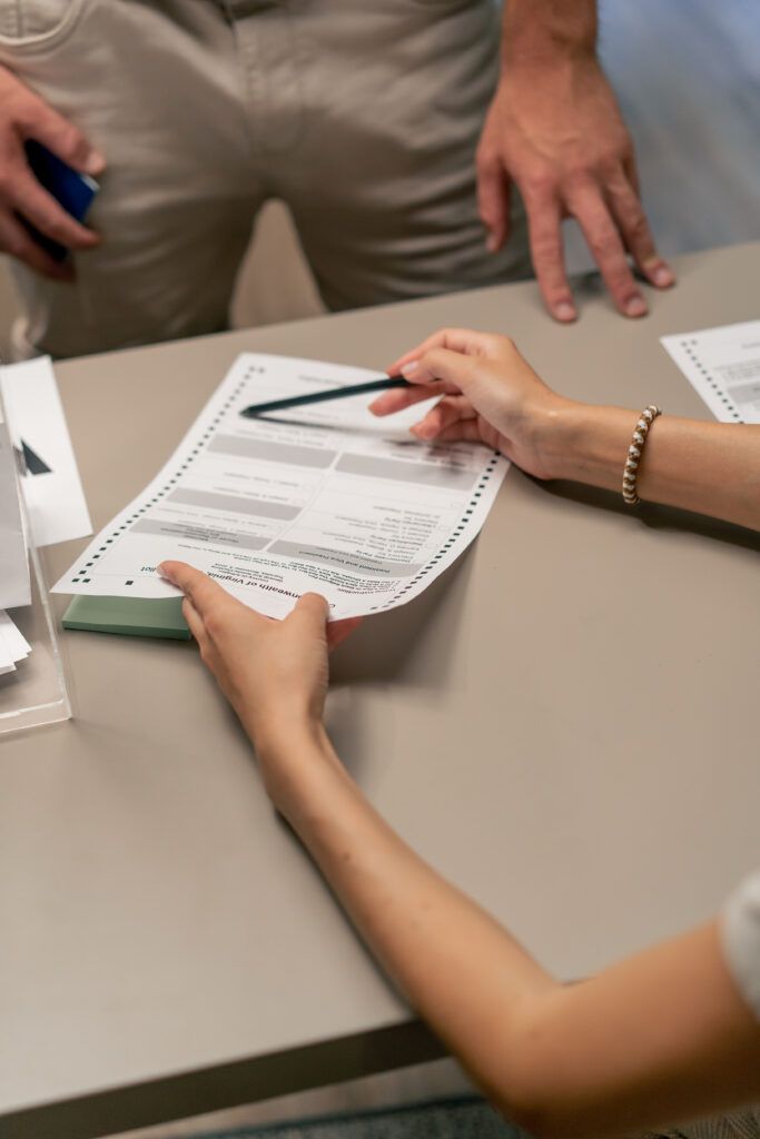 Hands reviewing and signing peace bond or restraining order paperwork at a desk during a legal process in Canadian criminal court.